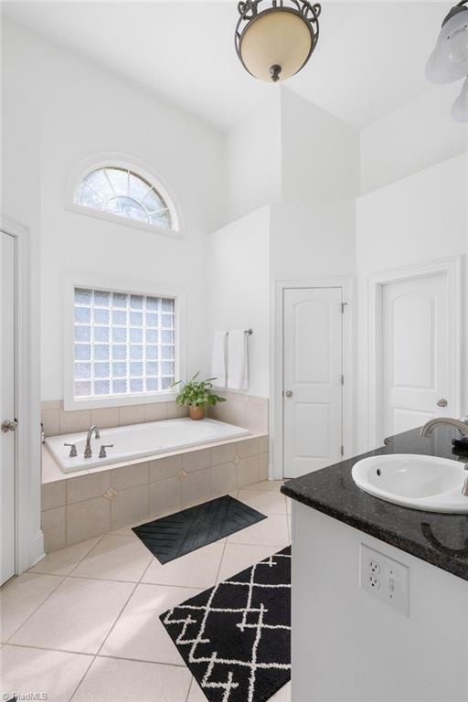7024 Denison Road Summerfield, NC 27358 - Photo 17 of 43 Primary Bathroom has volume ceiling and great natural light