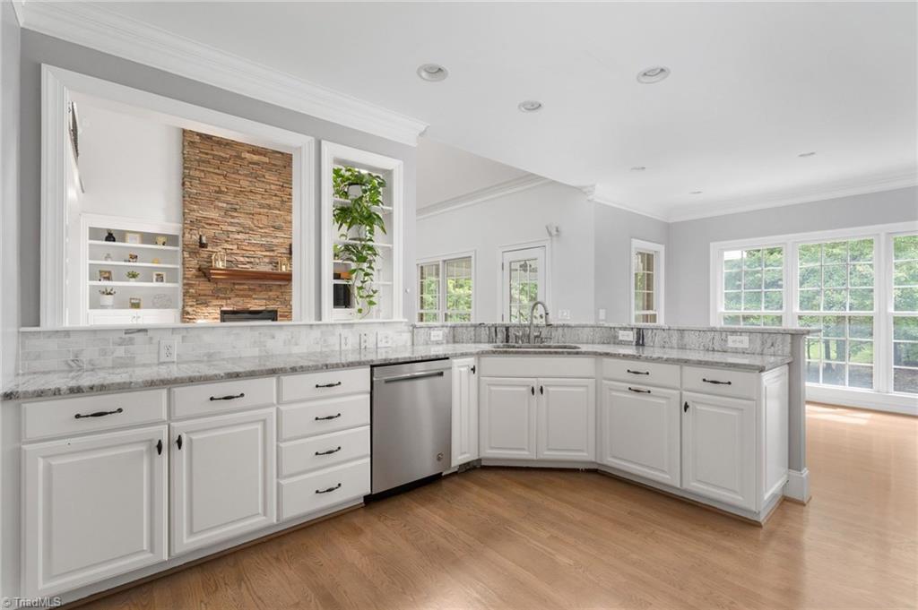 7024 Denison Road Summerfield, NC 27358 - Photo 9 of 43 Epicurean Kitchen is open to the Great Room & Breakfast Room with access to the Screened Porch