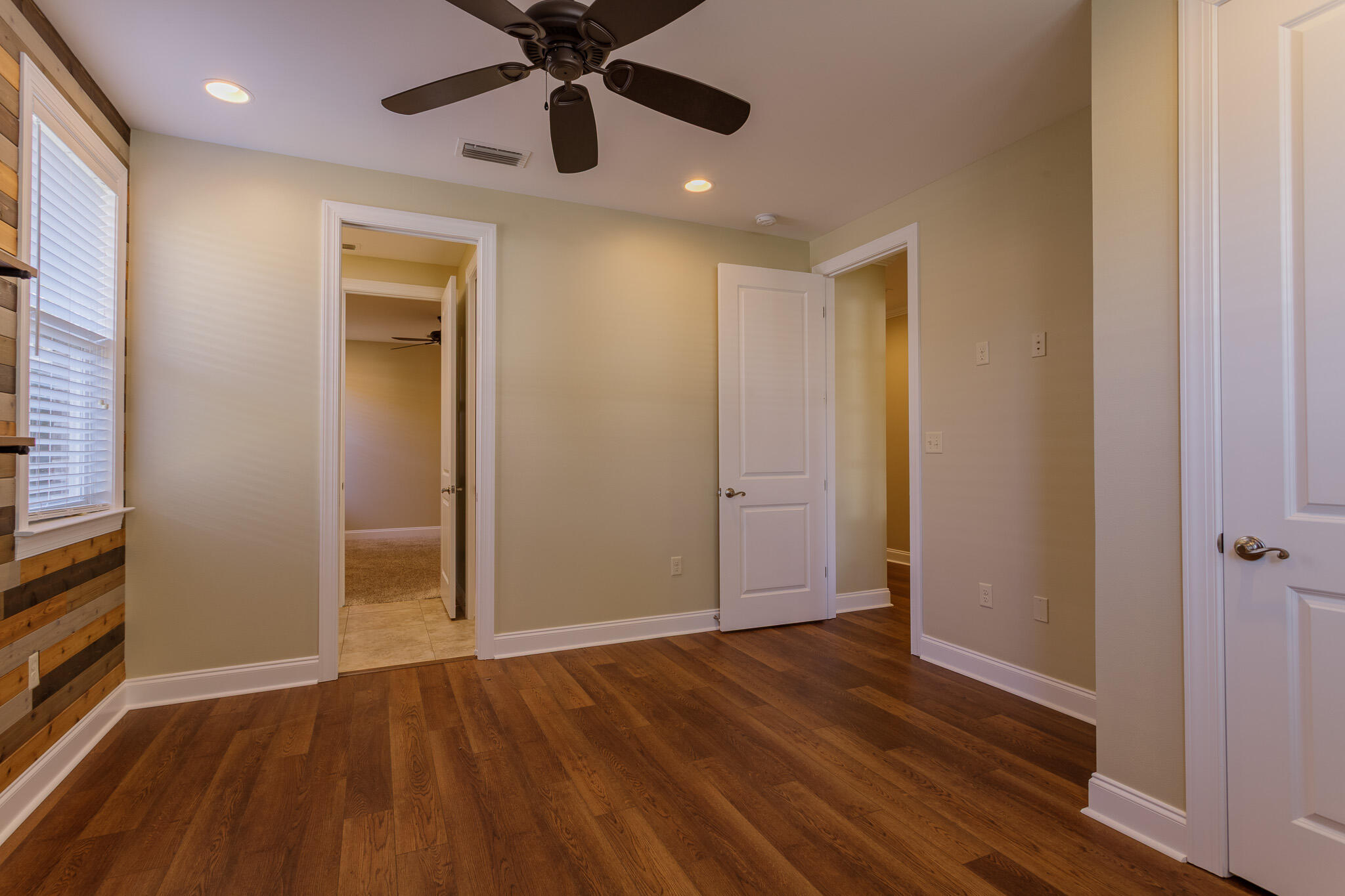 111 Arrowhead Way Niceville, FL 32578 - Photo 29 of 46 an empty room with wooden floor closet and windows