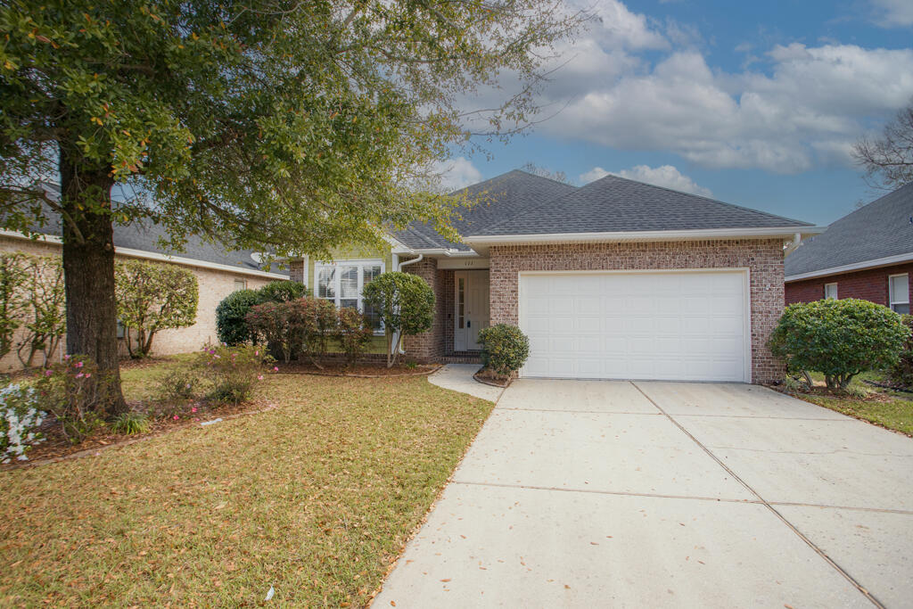 111 Arrowhead Way Niceville, FL 32578 - Photo 34 of 46 a front view of a house with a yard and garage