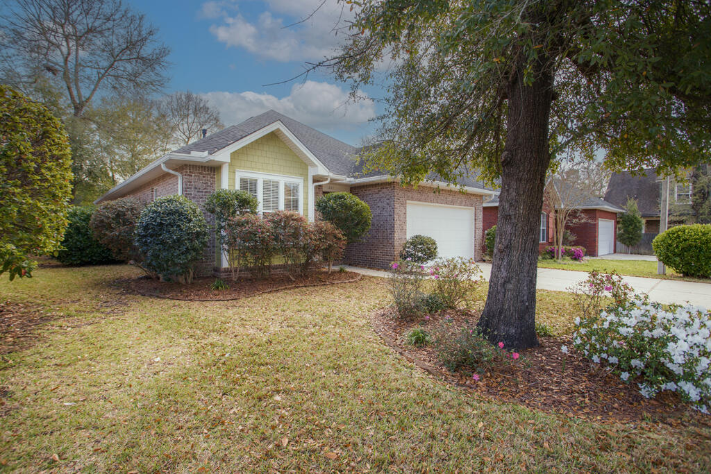 111 Arrowhead Way Niceville, FL 32578 - Photo 36 of 46 a front view of a house with garden