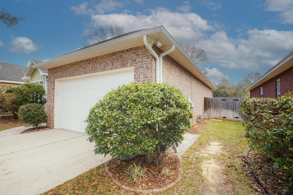 111 Arrowhead Way Niceville, FL 32578 - Photo 40 of 46 a front view of a house with garden