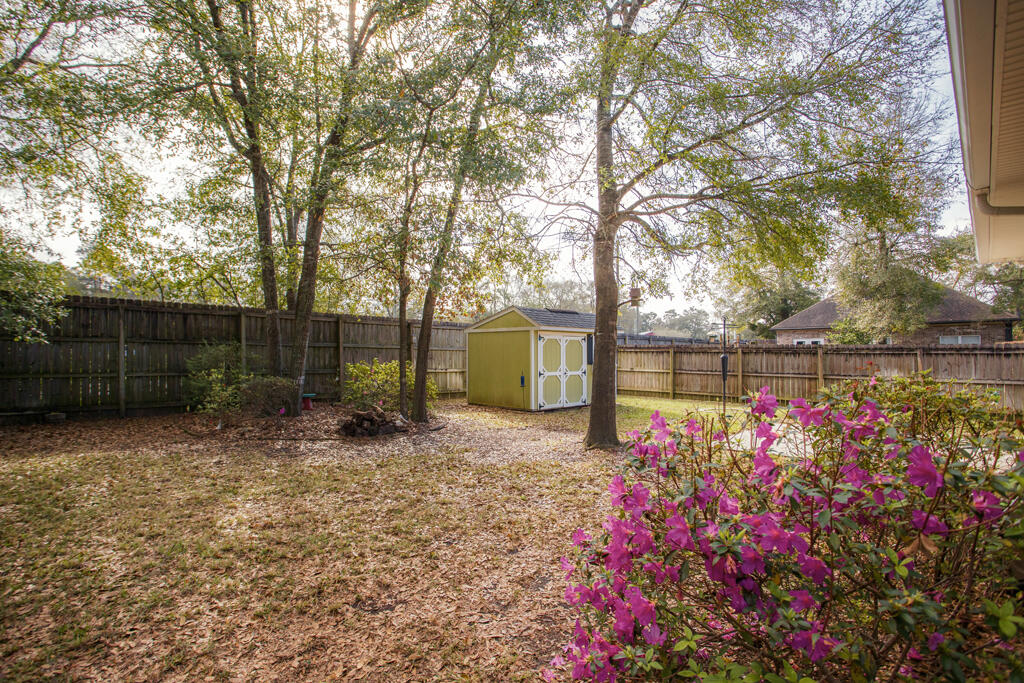 111 Arrowhead Way Niceville, FL 32578 - Photo 46 of 46 a view of a backyard with flowers and tree