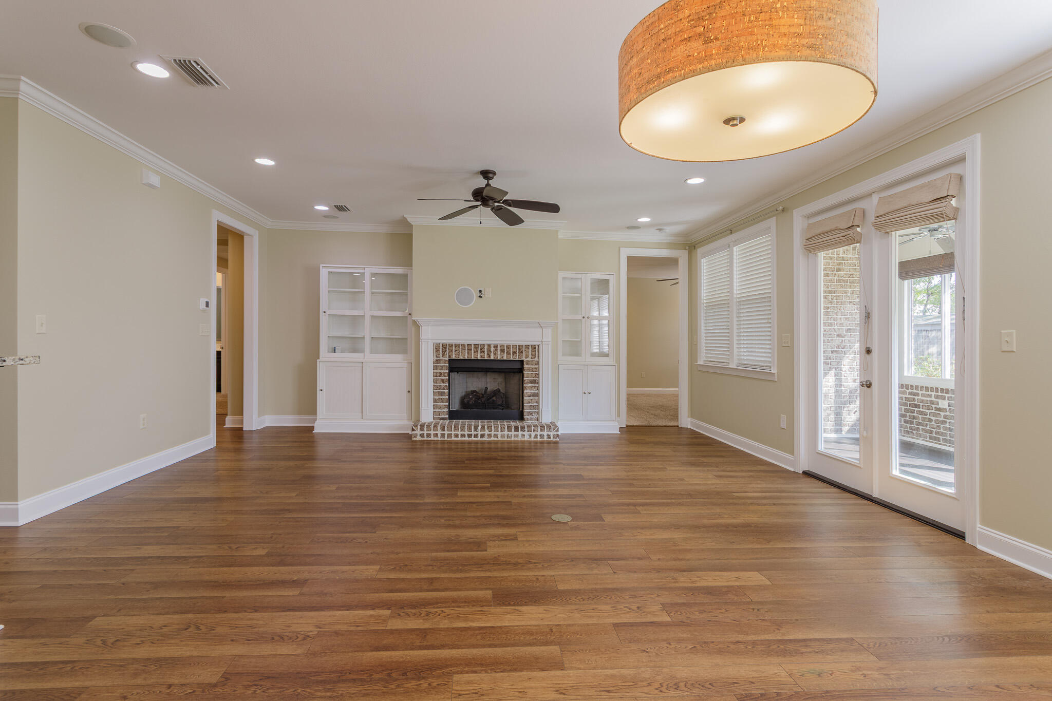 111 Arrowhead Way Niceville, FL 32578 - Photo 7 of 46 a view of an empty room with a fireplace and a chandelier