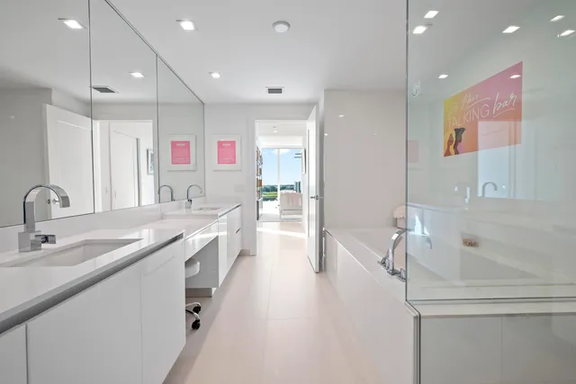 a spacious bathroom with a granite countertop sink mirror and bathtub