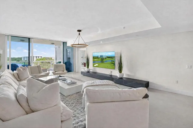 a living room with furniture a window and a chandelier