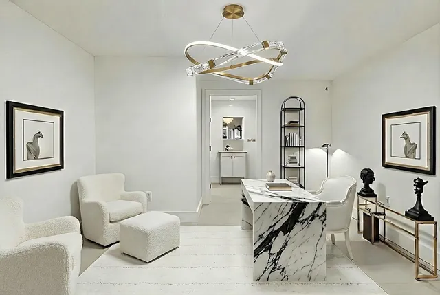 a living room with furniture a chandelier and a mirror