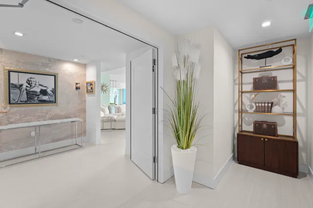 a living room with furniture and a potted plant