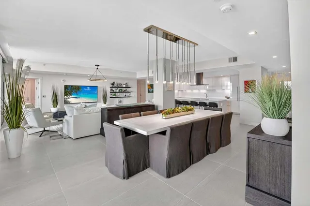 a kitchen with stainless steel appliances kitchen island granite countertop a stove a sink dishwasher and a refrigerator