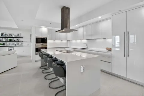 a kitchen with a sink stainless steel appliances and cabinets