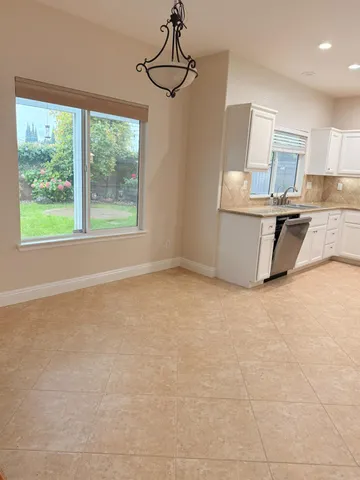 a view of a kitchen with furniture and a window
