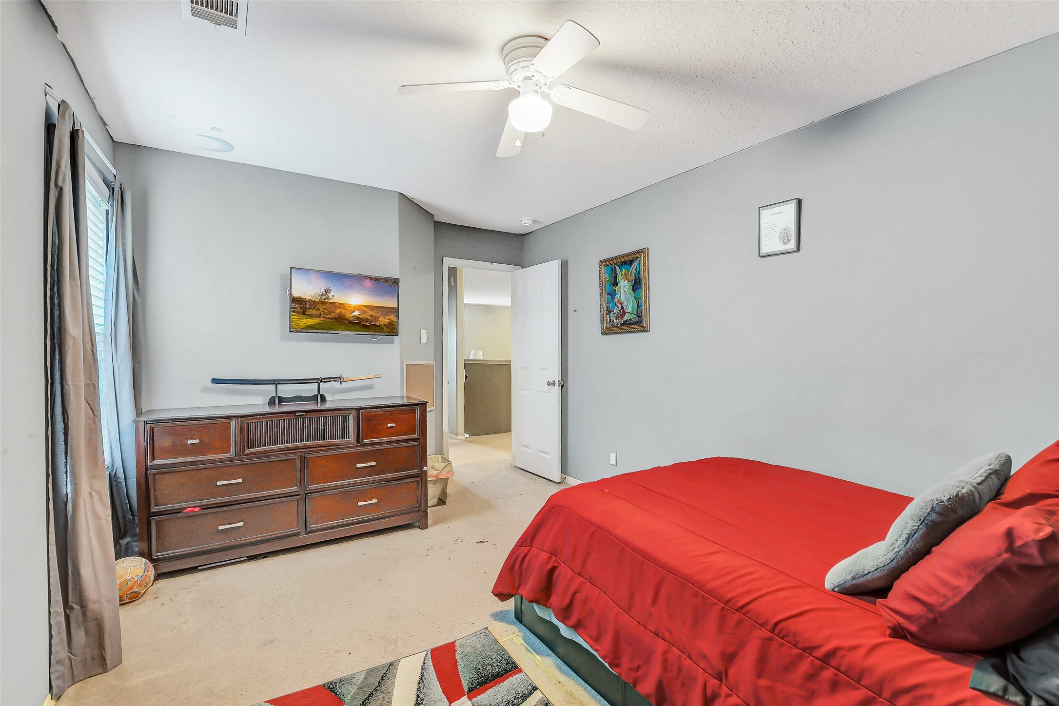 3407 Apple Dale Drive Houston, TX 77084 - Photo 28 of 37 a bedroom with a bed and a chandelier