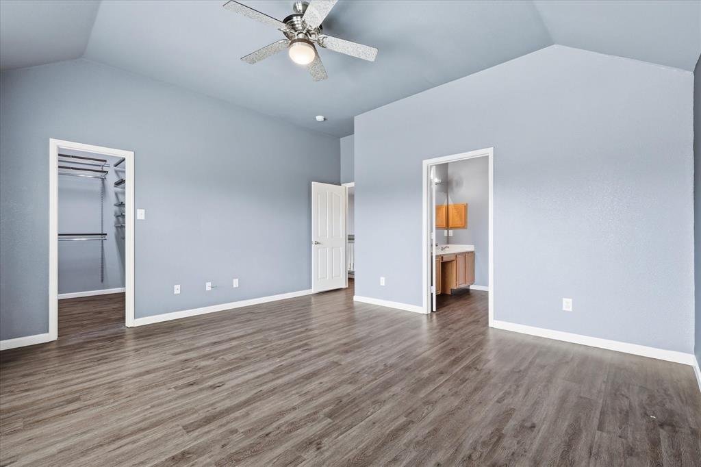 4545 Ridgepointe Drive The Colony, TX 75056 - Photo 24 of 37 Vaulted ceilings with a ceiling fan, wood-finish flooring, and white trim