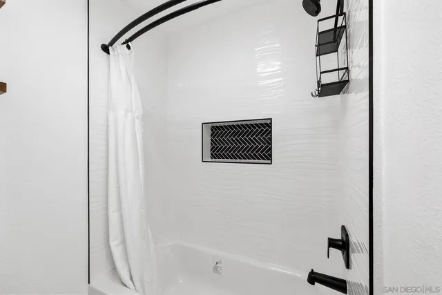 a bathroom with a shower and a bathtub