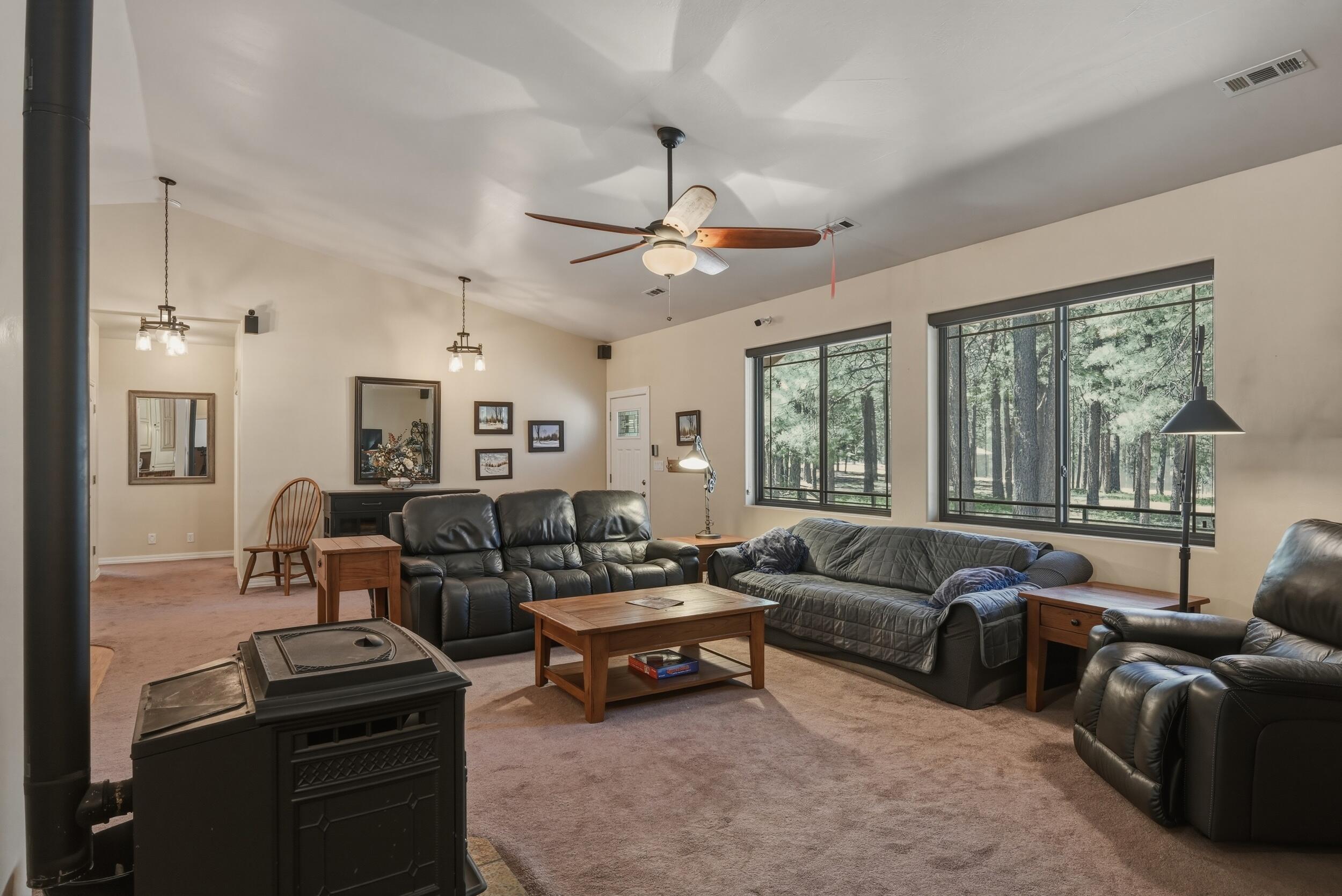 1233 Merzville Road Forest Lakes, AZ 85931 - Photo 7 of 39 a living room with furniture ceiling fan and a window