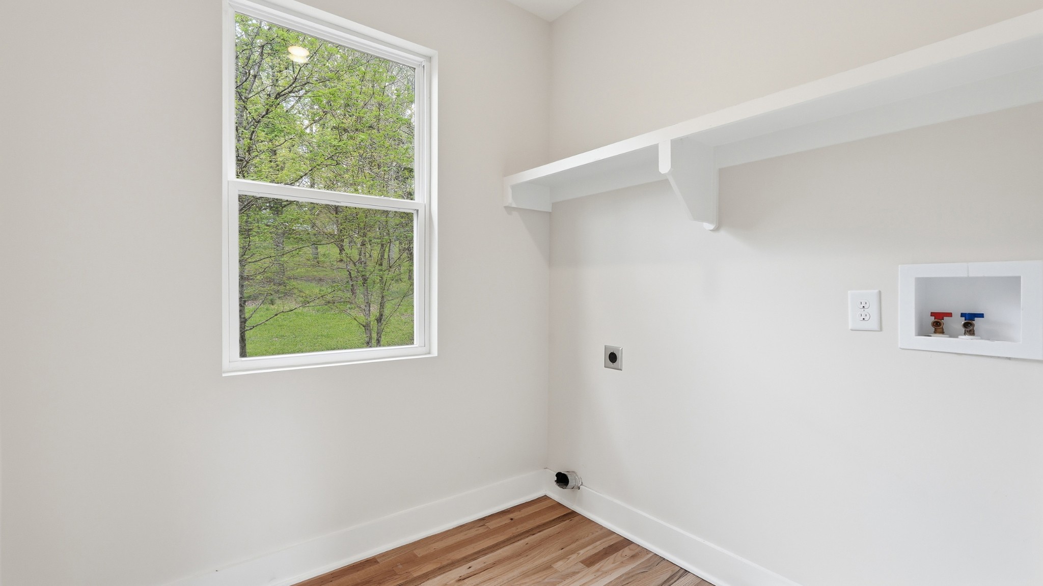 2005 Beaver Ridge Road White Bluff, TN 37187 - Photo 35 of 46 a view of an empty room with wooden floor and a window