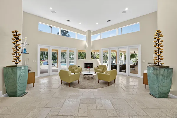 a living room with furniture and kitchen view