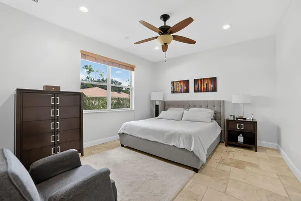 a kitchen with stainless steel appliances granite countertop a refrigerator a stove and white cabinets with wooden floor