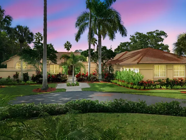 a backyard of a house with a garden and outdoor seating