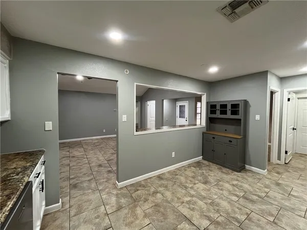 a kitchen with a refrigerator and a stove top oven