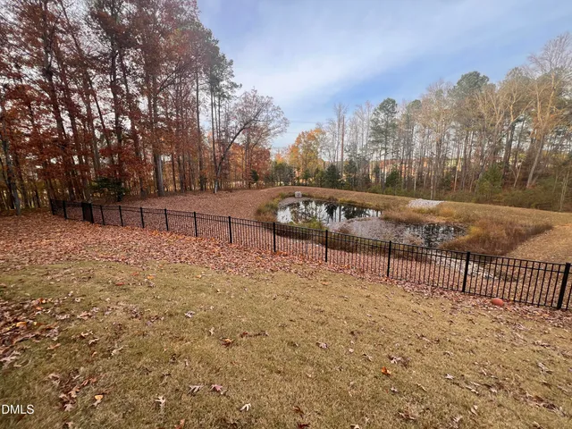 a kitchen with stainless steel appliances granite countertop a refrigerator a stove a sink dishwasher and a microwave with wooden floor