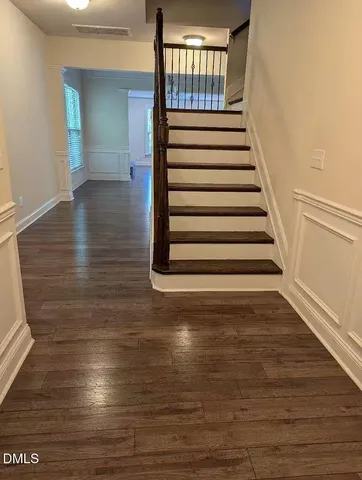 a kitchen with stainless steel appliances granite countertop wooden cabinets a refrigerator a stove a sink and a oven