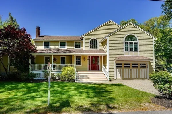 a front view of a house with a garden