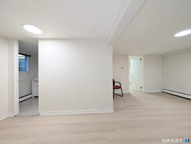 a view of a hallway with closet and front door