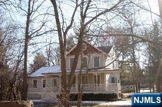 4 Lee Court Waldwick, NJ 07463 - Photo 3 of 15 a front view of a house with a tree