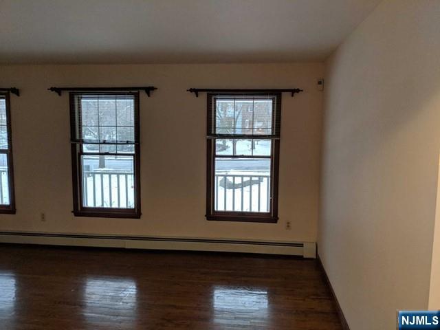 4 Lee Court Waldwick, NJ 07463 - Photo 7 of 15 a view of an empty room with wooden floor and a window