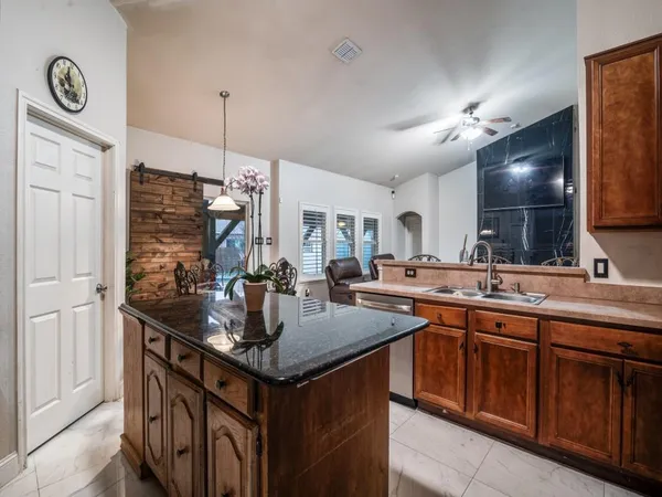 a kitchen with granite countertop a sink and cabinets