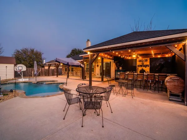 a view of swimming pool with outdoor seating