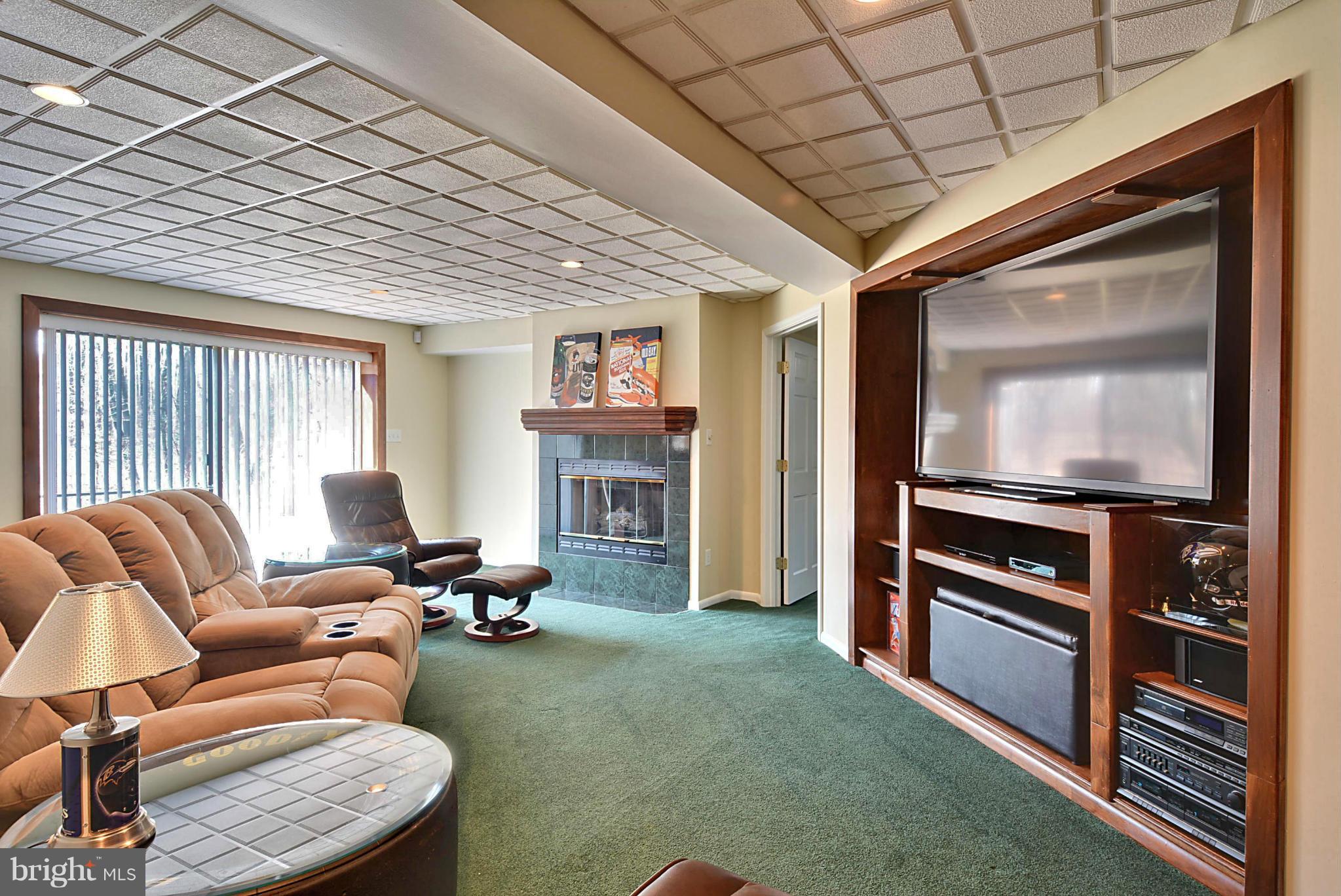 9805 Old Court Road Baltimore, MD 21244 - Photo 22 of 30 a living room with furniture a flat screen tv and a fireplace