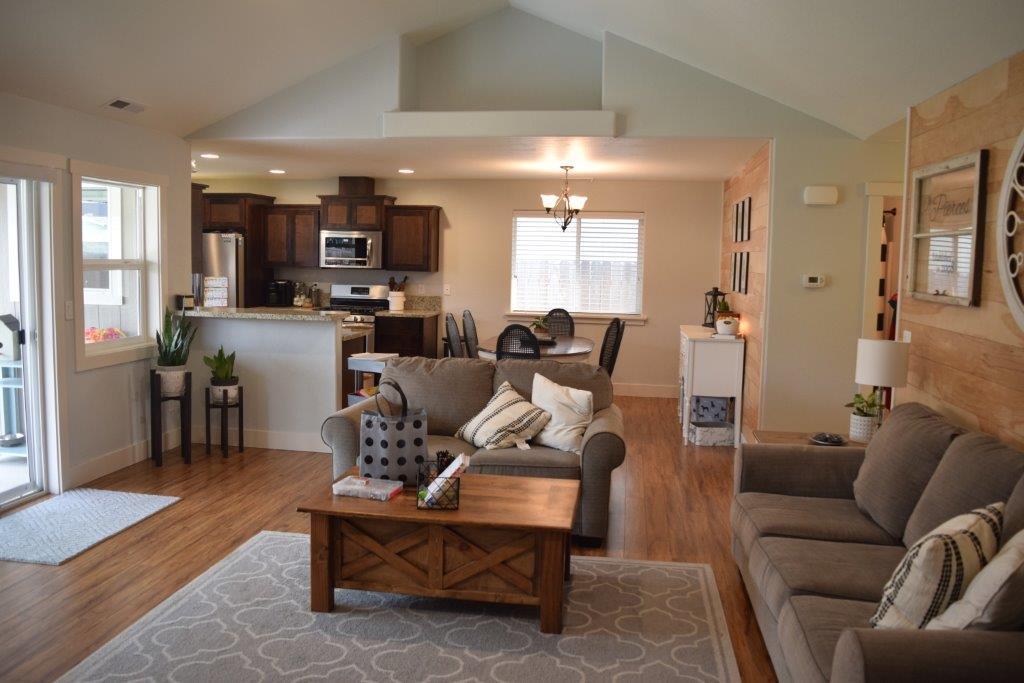 906 Win Way Eagle Point, OR 97524 - Photo 14 of 33 a living room with furniture kitchen view and a wooden floor
