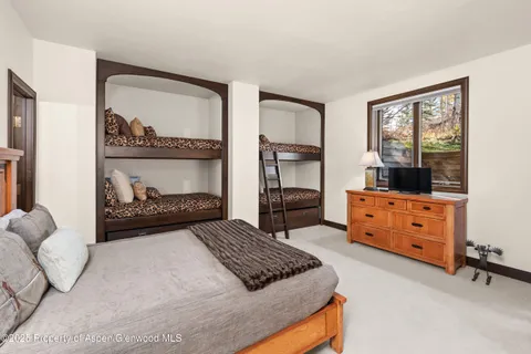 a bedroom with a bed and a dresser in it