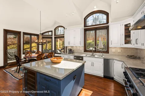 a kitchen with a sink stove and cabinets