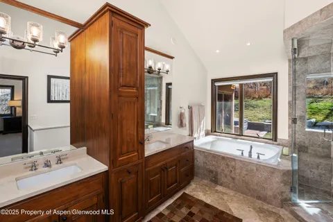 a bathroom with a tub and a shower