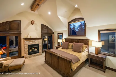 a bedroom with a bed and a fireplace