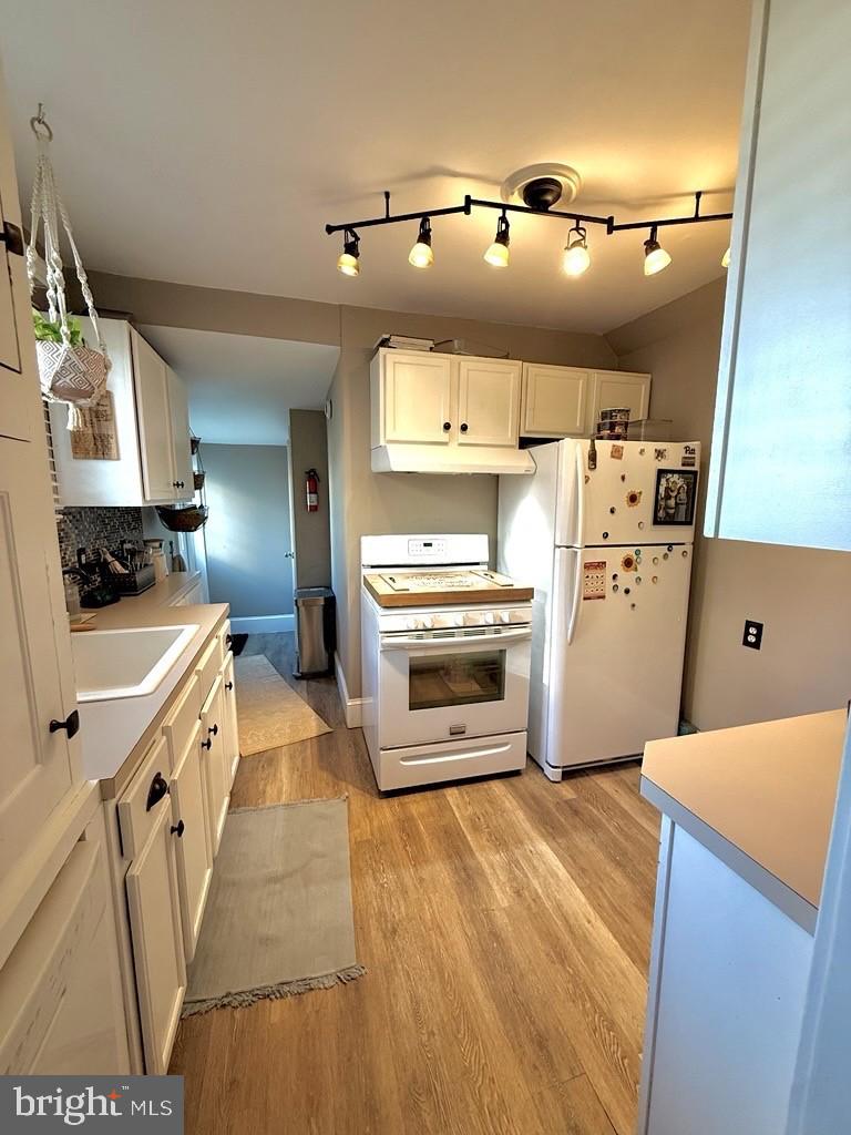 65 Arbutus Avenue Pitman, NJ 08071 - Photo 12 of 28 a kitchen with cabinets and wooden floor