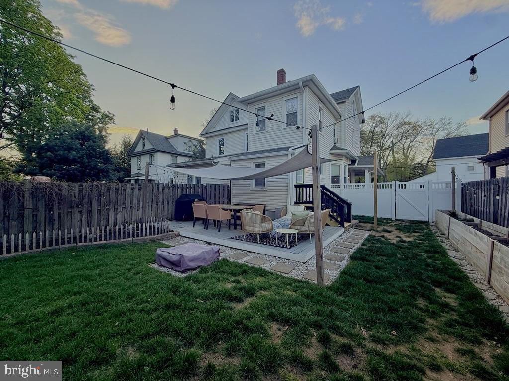 65 Arbutus Avenue Pitman, NJ 08071 - Photo 26 of 28 a view of a patio with table and chairs with wooden fence