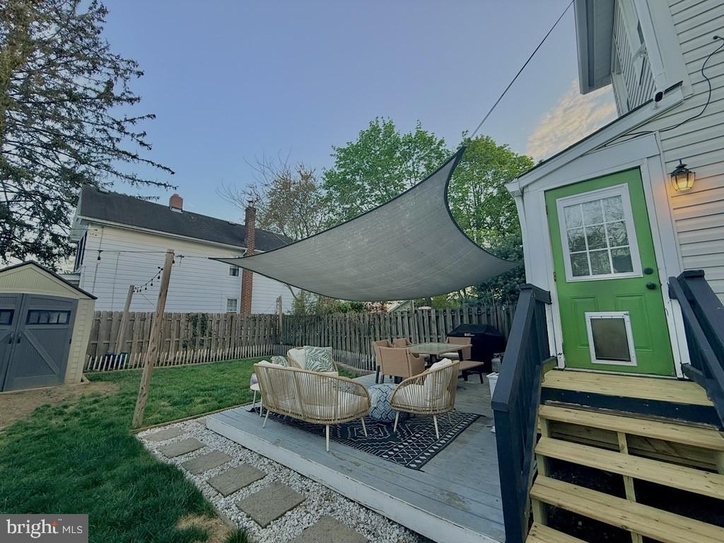 65 Arbutus Avenue Pitman, NJ 08071 - Photo 27 of 28 a view of a patio with table and chairs with wooden fence and floor