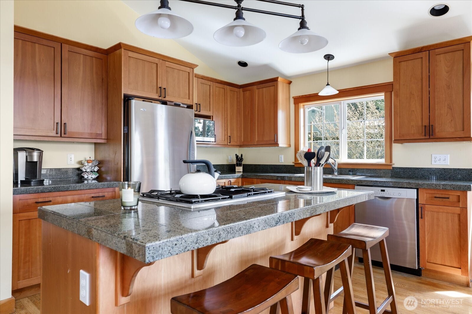 8210 Nob Road Clinton, WA 98236 - Photo 13 of 40 a kitchen with granite countertop a sink stainless steel appliances and cabinets