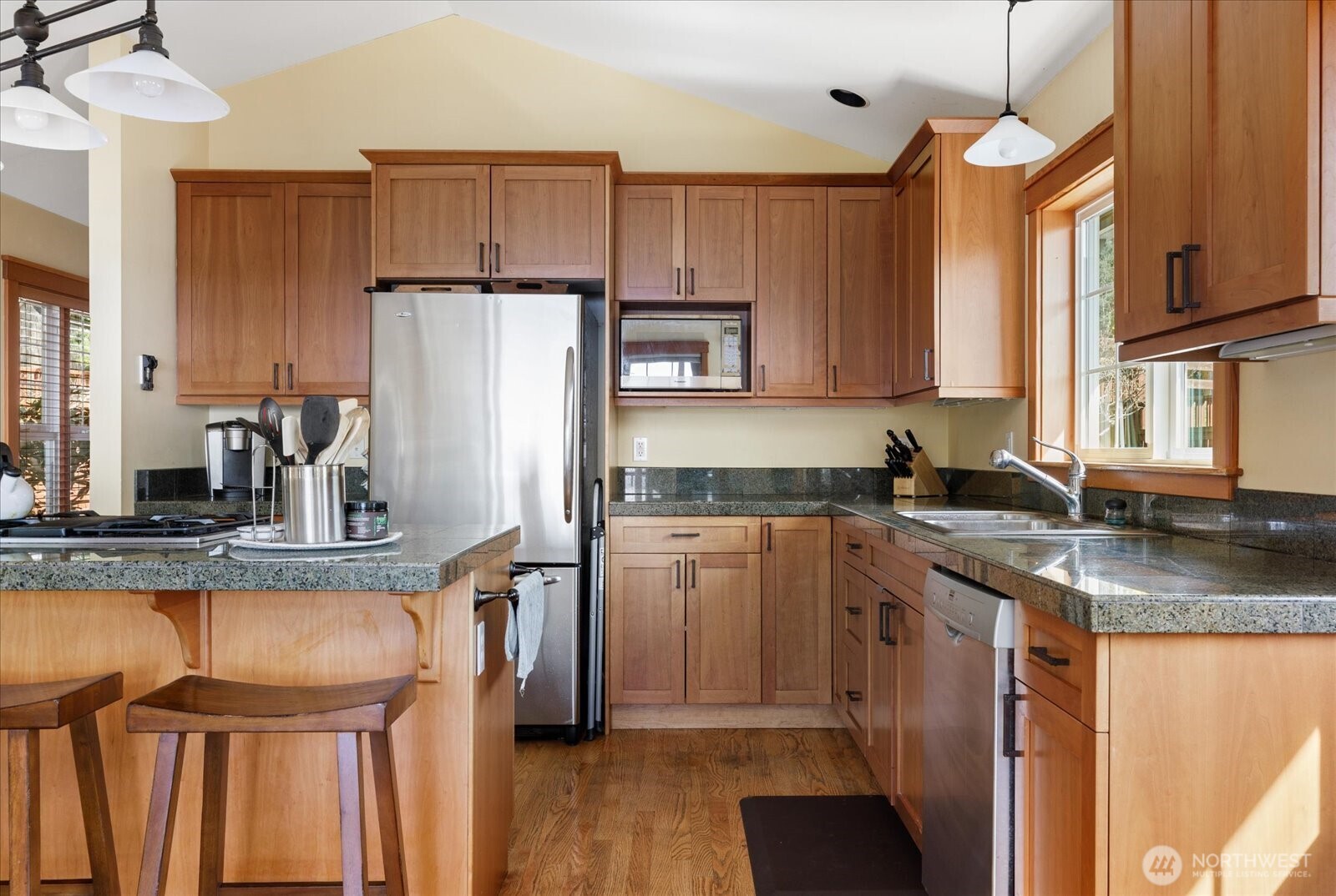 8210 Nob Road Clinton, WA 98236 - Photo 14 of 40 a kitchen with stainless steel appliances granite countertop a sink refrigerator and cabinets