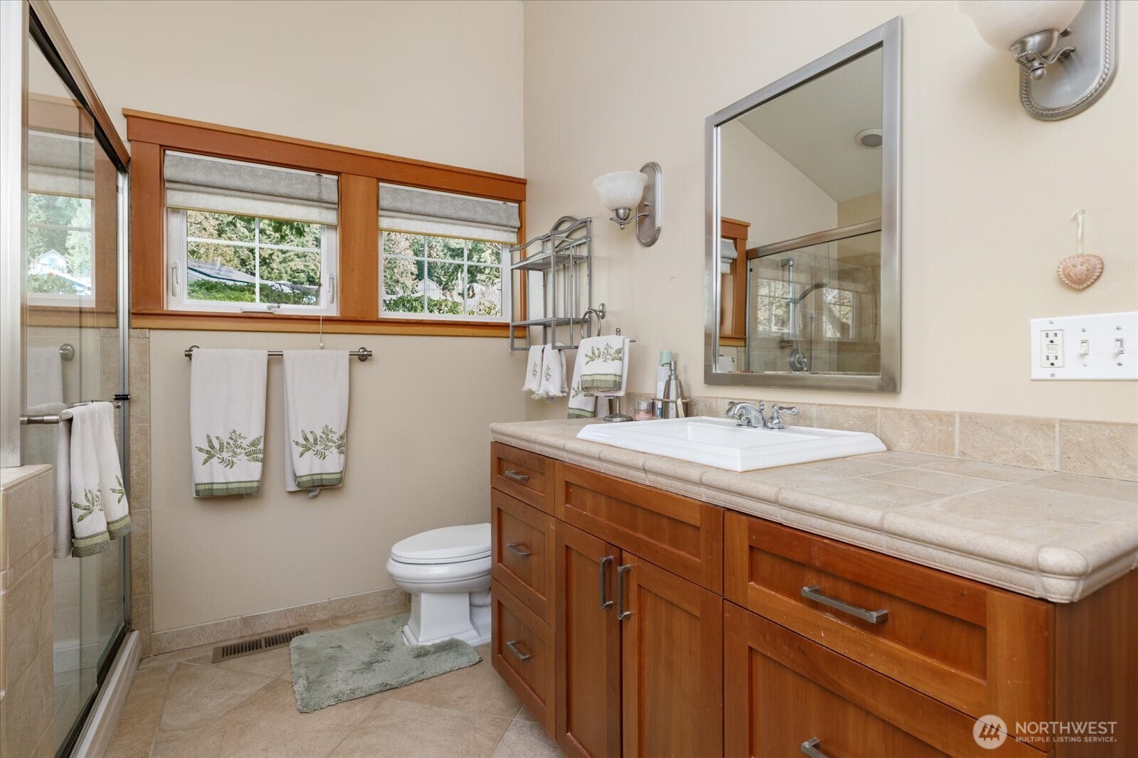 8210 Nob Road Clinton, WA 98236 - Photo 20 of 40 a bathroom with a granite countertop sink mirror and toilet