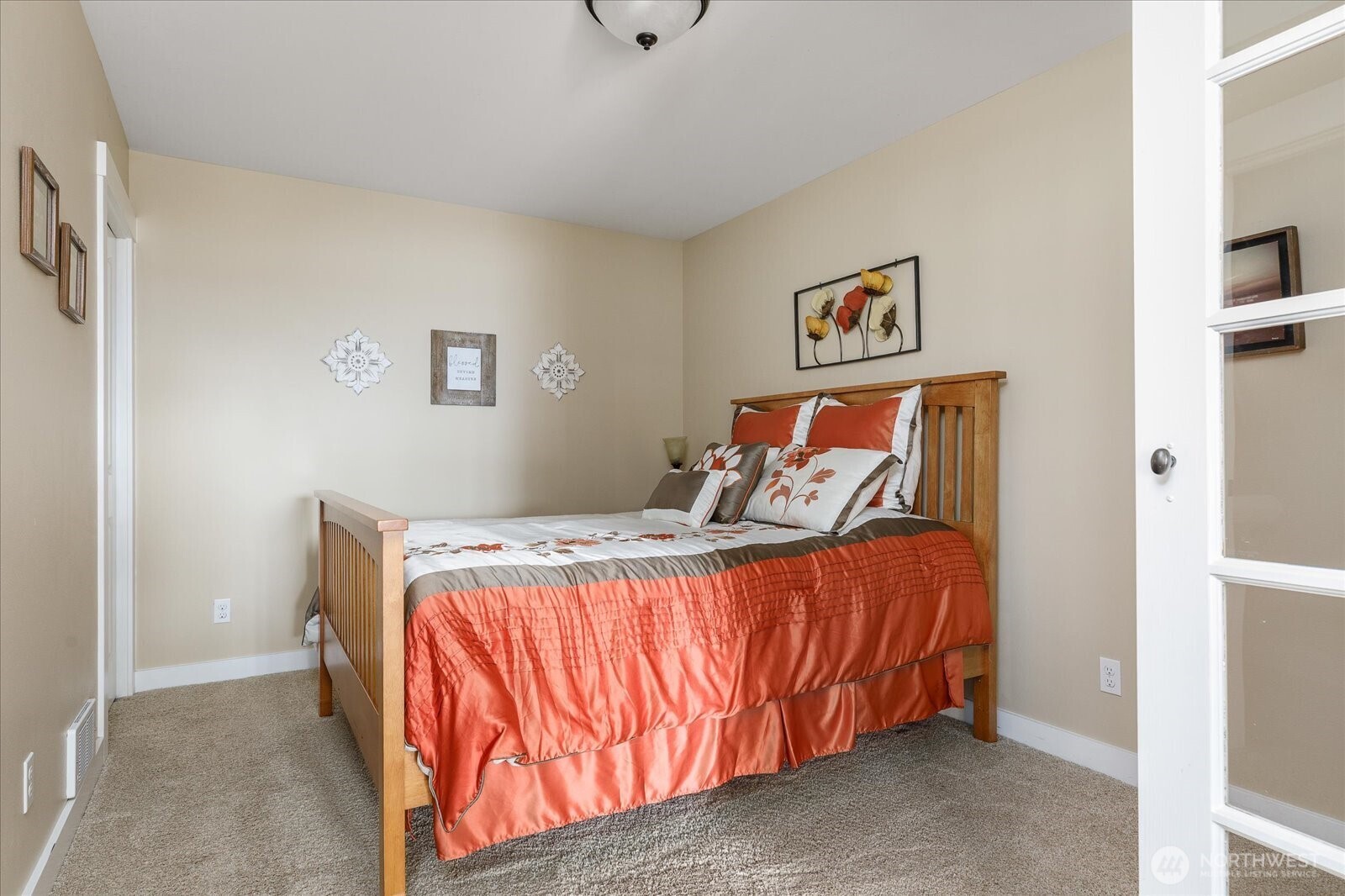 8210 Nob Road Clinton, WA 98236 - Photo 30 of 40 a bed sitting in a bedroom next to a cabinet