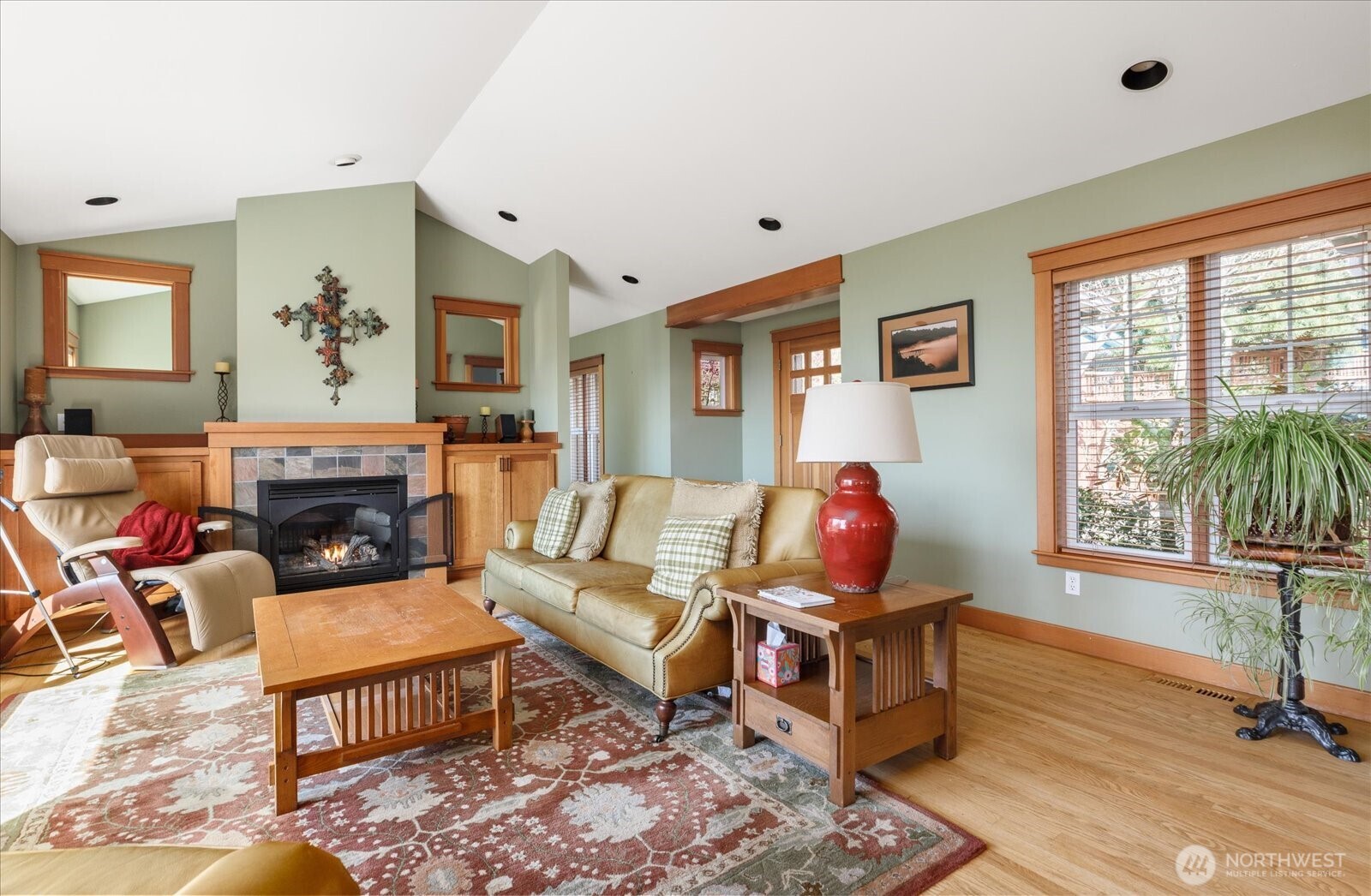 8210 Nob Road Clinton, WA 98236 - Photo 6 of 40 a living room with furniture a fireplace and a flat screen tv