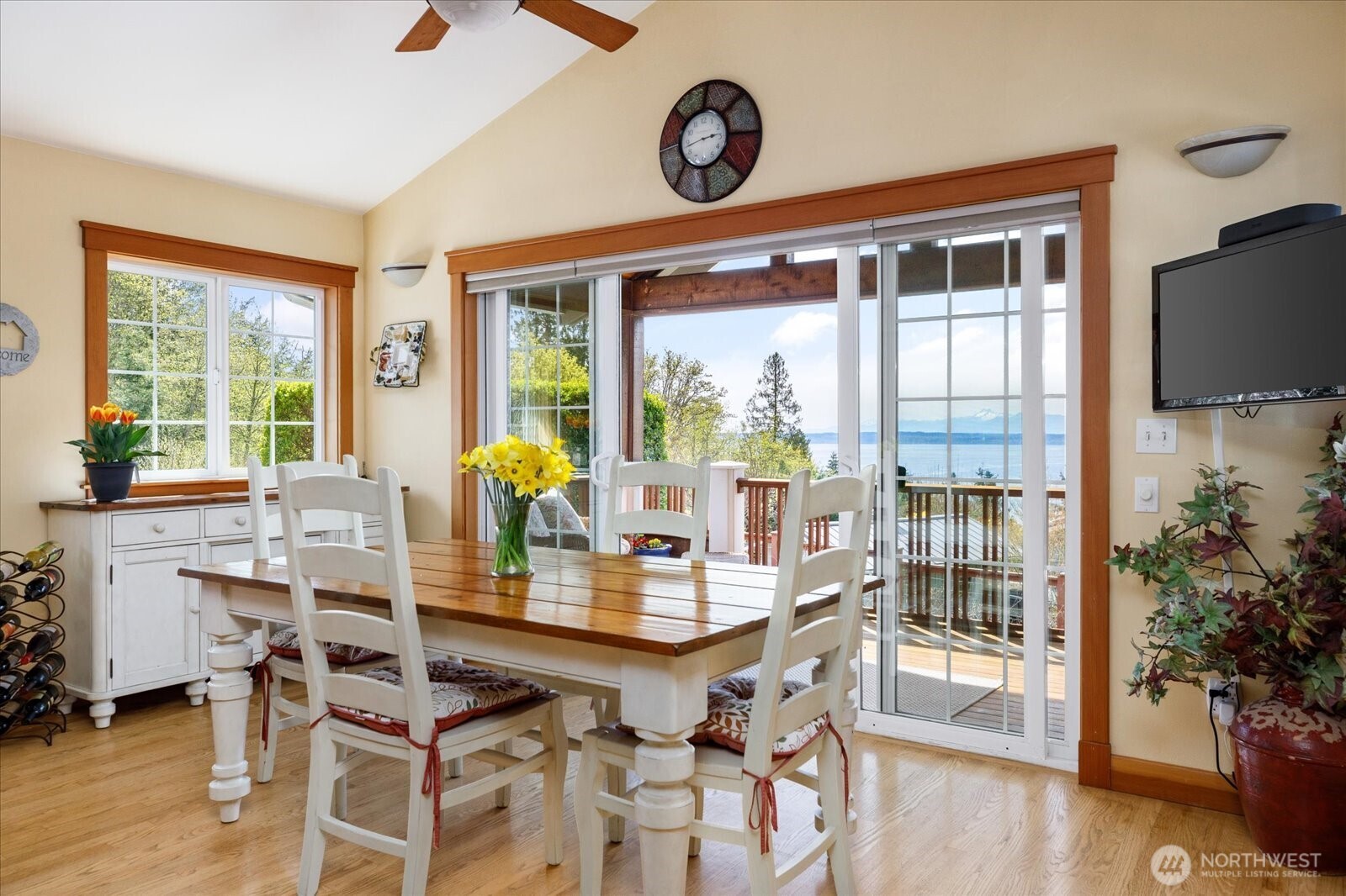 8210 Nob Road Clinton, WA 98236 - Photo 8 of 40 a view of a dining room with furniture window and wooden floor