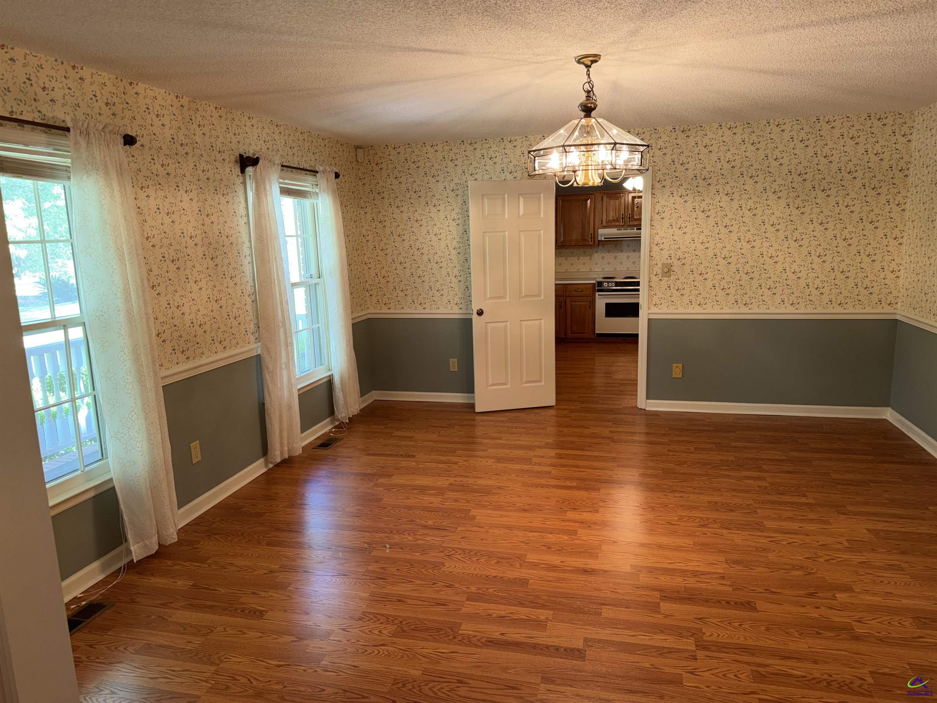 249 Hatcher Road Warner Robins, GA 31088 - Photo 10 of 25 a view of a room with wooden floor and windows