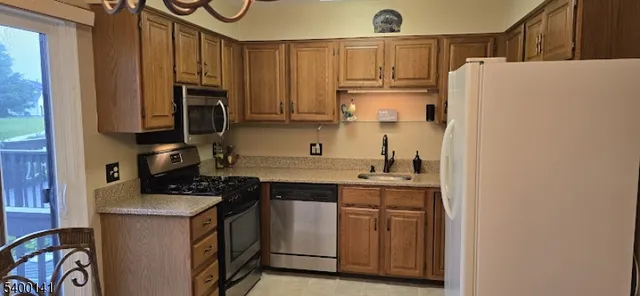 a kitchen with a refrigerator and a sink