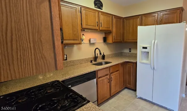a kitchen with stainless steel appliances a refrigerator and a sink